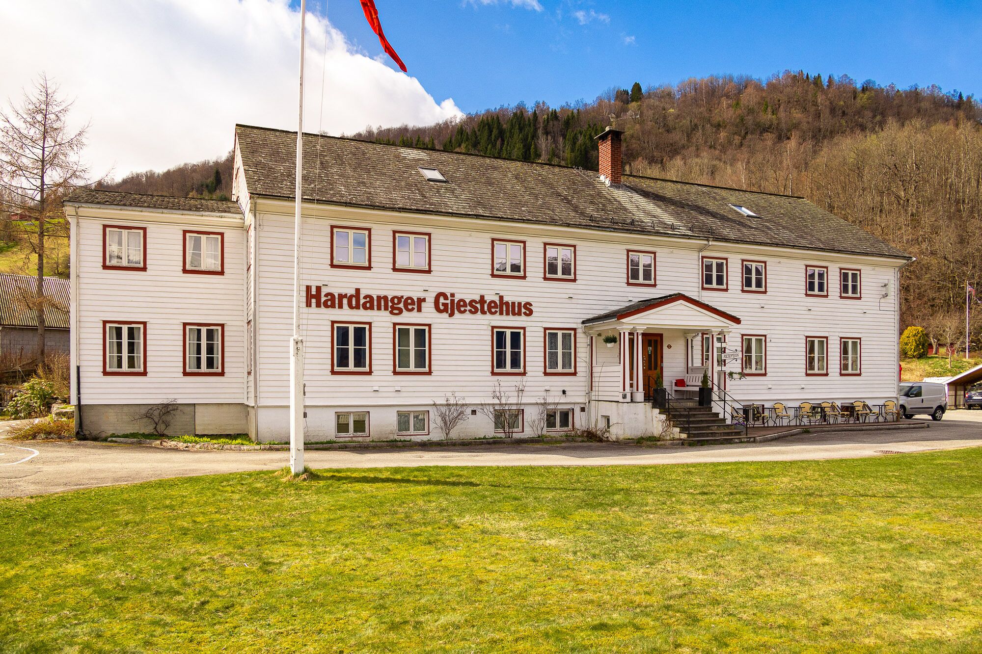 A two-story building with the name "Hardanger Gjesthus" on the facade.