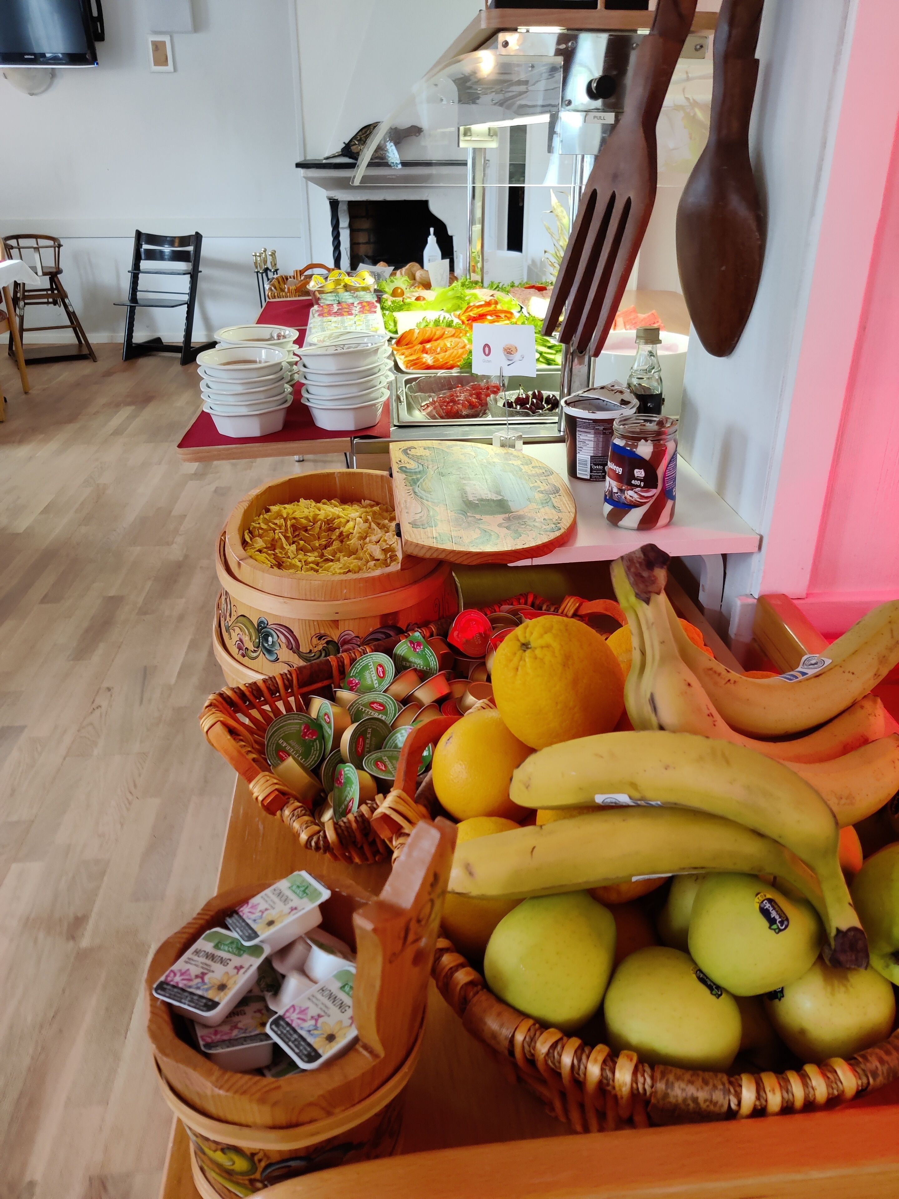 A buffet setup with various food items and utensils.