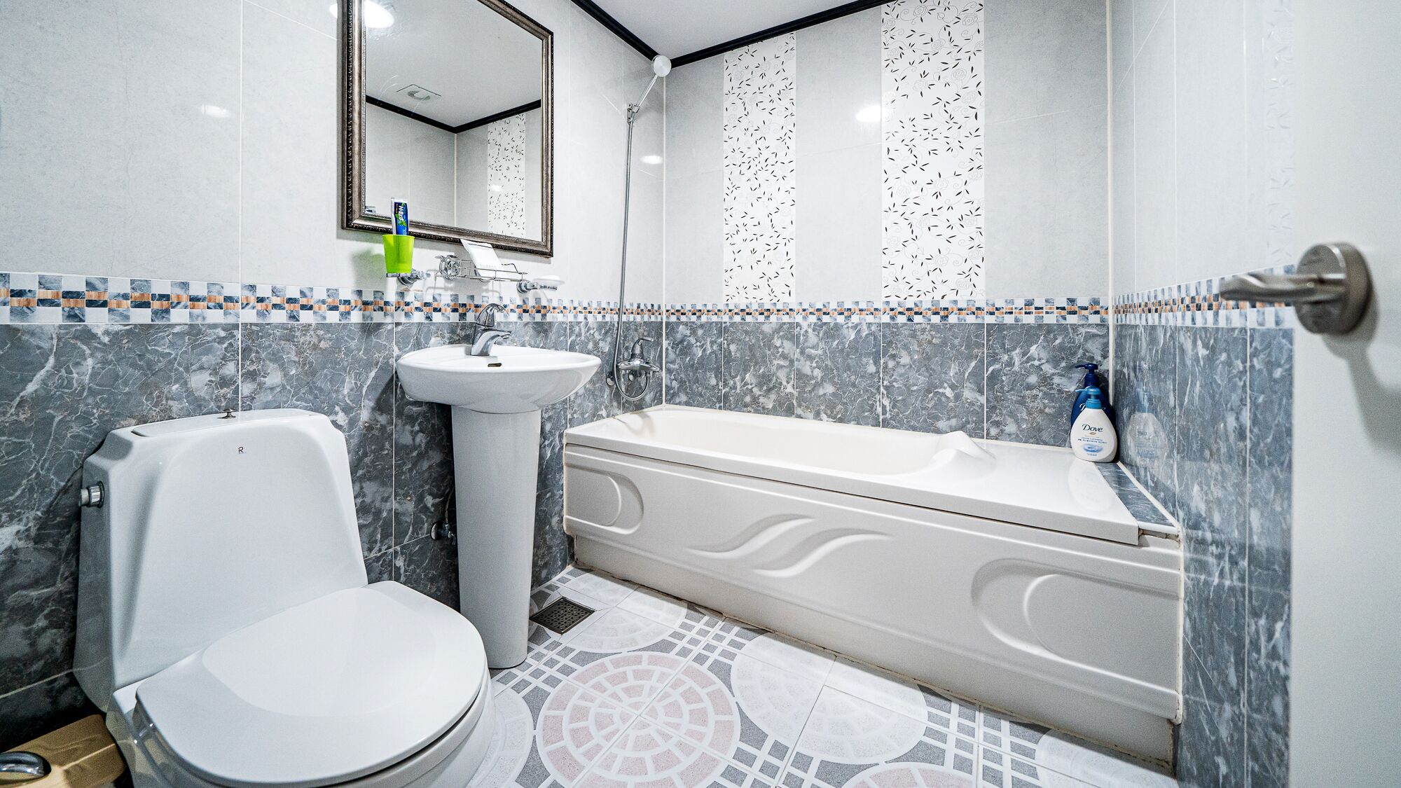A bathroom with a toilet, sink, and bathtub.