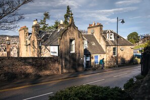 A stone building with a sign for 'Bopockers' and a visible entrance. - Bazpackers Hostel (Inverness)