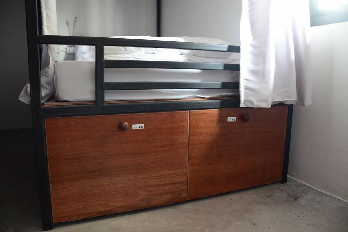 A wooden cabinet with two doors, each marked with a label.