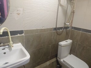 A bathroom with a sink, toilet, and shower.