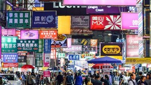 A busy street with numerous signs and advertisements in a foreign language.