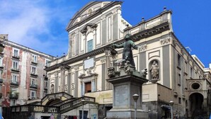 A historic building with classical architecture, including a statue and ornate details. - Bien-Bì (Naples)