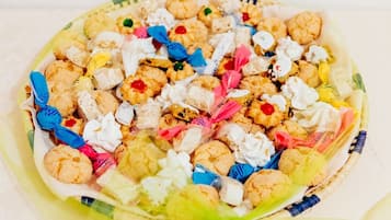 A plate of assorted cookies and candies, some wrapped in colorful paper.
