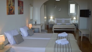 A hotel room with two beds, a desk, and a TV. - Sofia (Apokoronas)