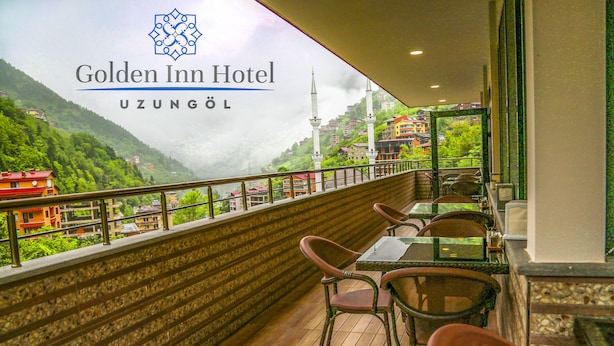 A balcony with a view of a mountainous landscape, a table with chairs, and a railing. - Golden Inn Hotel Uzungol (Çaykara)