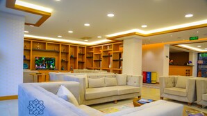 A hotel lobby with sofas, a television, and a reception desk. - Golden Inn Hotel Uzungol (Çaykara)