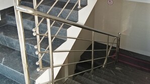 A staircase with metal railings and stone steps.