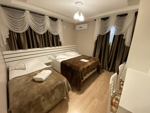 A hotel room with two beds, a white ceiling, and a white radiator. - Pousada Vovô Nino (Gramado)