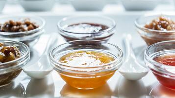 A table with various small bowls containing different types of condiments.