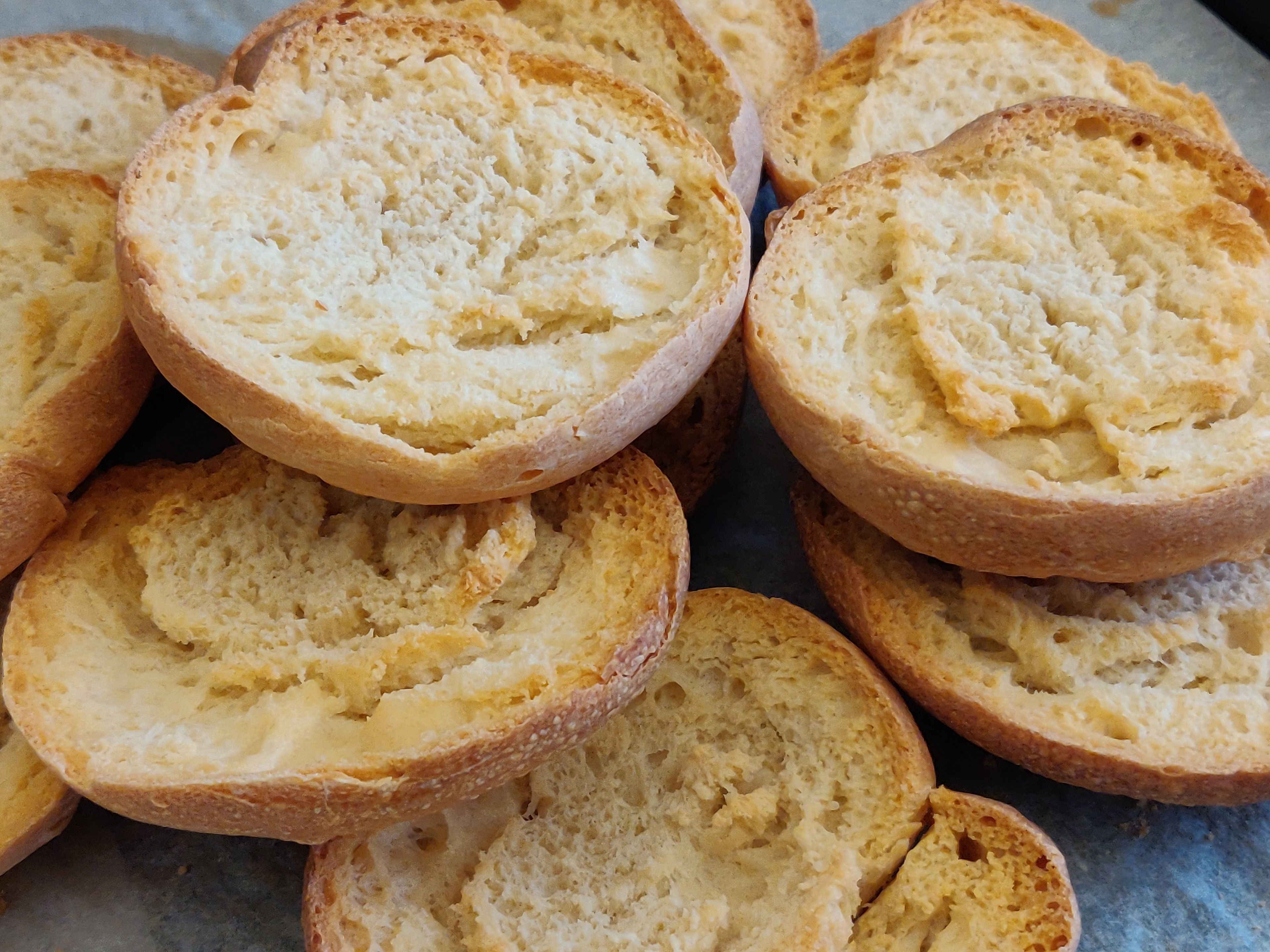 A close-up of sliced bread with a golden-brown crust.