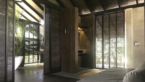 A modern bedroom with a large bed, wooden flooring, and a view through a sliding door. - KAJU GREEN eco lodges (Unawatuna)