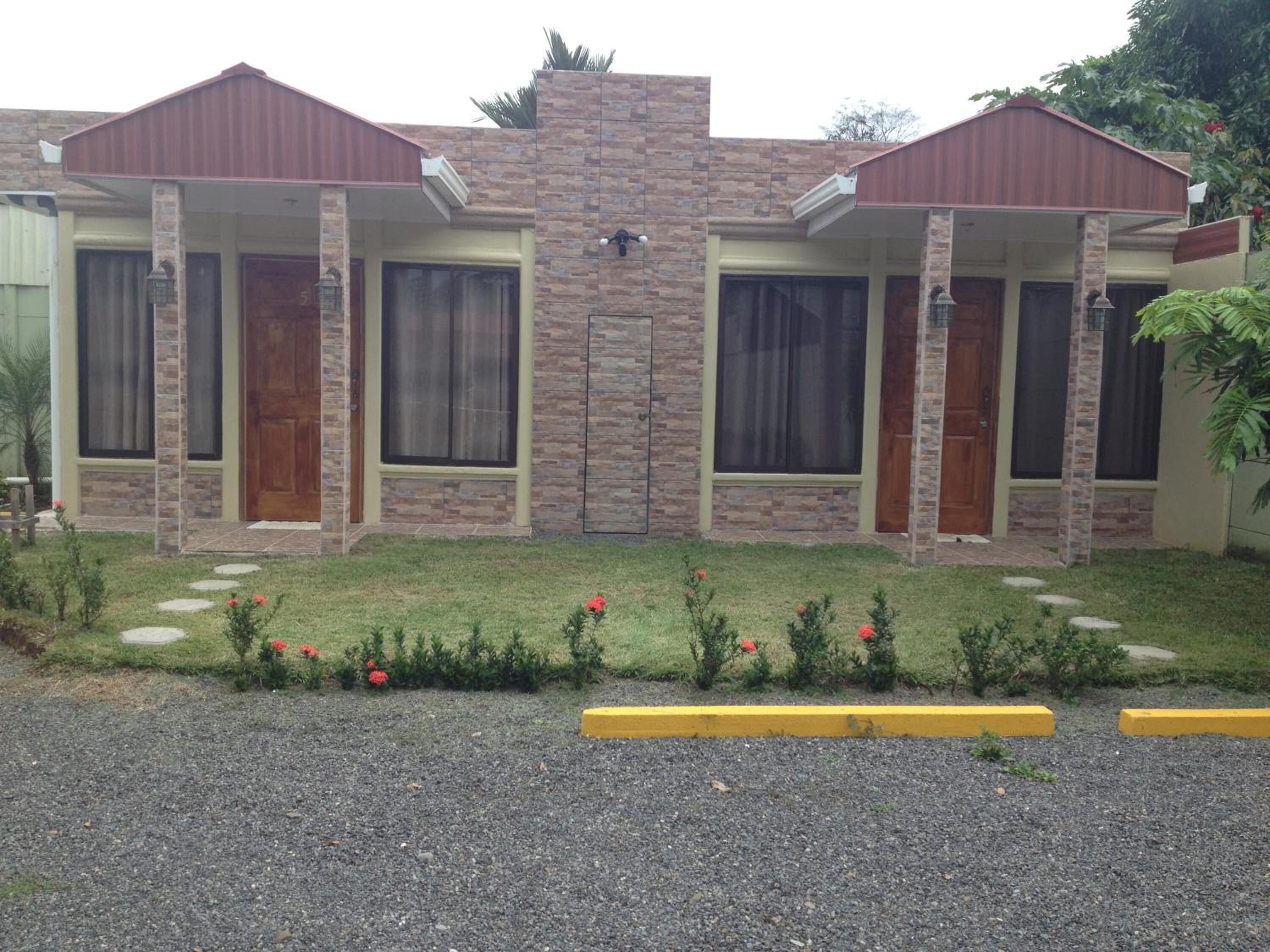 A two-story building with a stone facade and a flat roof.