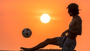 A person playing soccer on a beach at sunset. - Wonderland Hostel By GB Collection (Cartagena)