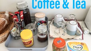 A tray with coffee and tea items including instant coffee, Nescafe, tea bags, a jar of peanut butter, a jar of ginger lime marmalade, and Flora Light yogurt. - Caversham B&B (Beechboro)
