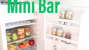 A mini fridge stocked with fruits, vegetables, condiments, and beverages. - Caversham B&B (Beechboro)