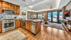 A modern kitchen with wooden cabinets, stainless steel appliances, and a large island. - 2 Br 2 Ba Luxury Condo. Walk to South Lake Tahoe! (South Lake Tahoe)