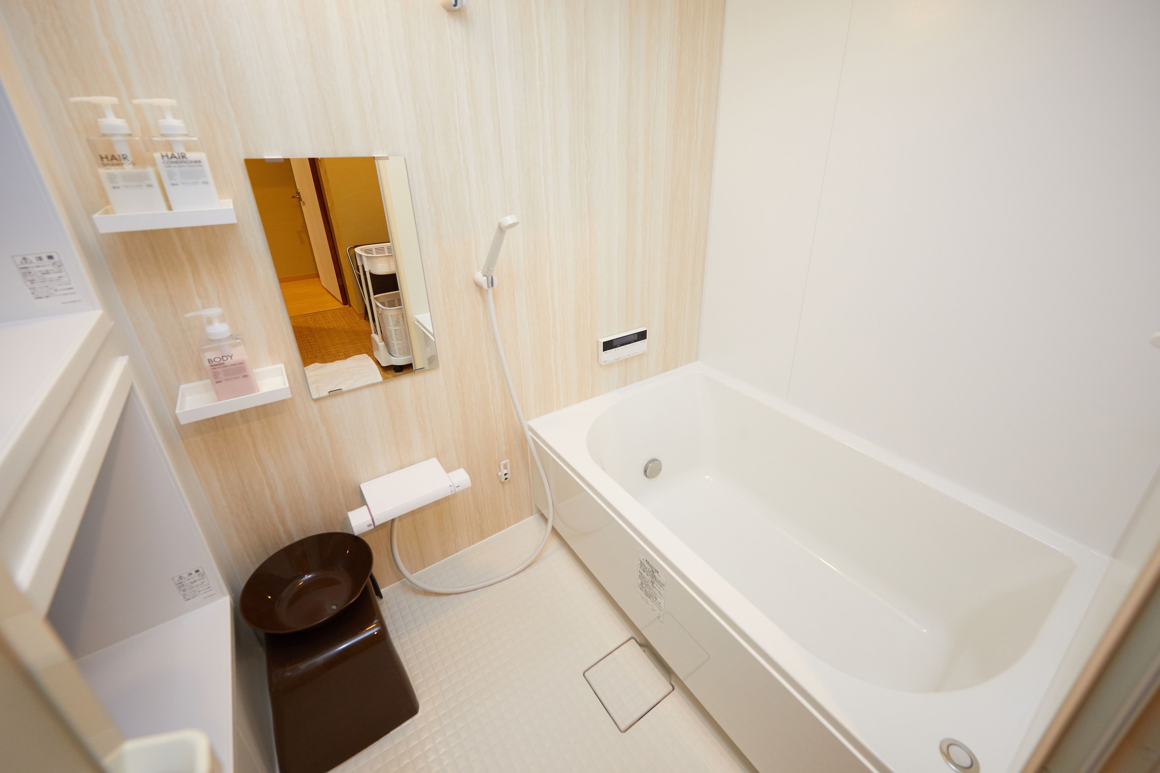 A modern bathroom with a bathtub, a toilet, and a shower area.