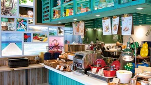 A buffet area with a variety of food items, a coffee machine, and a counter with a menu. - La'gent Hotel Okinawa Chatan - Hostel (Chatan)