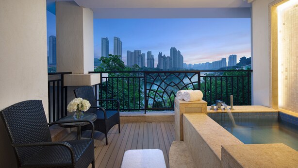 A balcony with a city view, a hot tub, and seating area. - C&D Hotel Putian (Putian)
