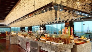 A buffet with various food items and a decorative ceiling. - C&D Hotel Putian (Putian)