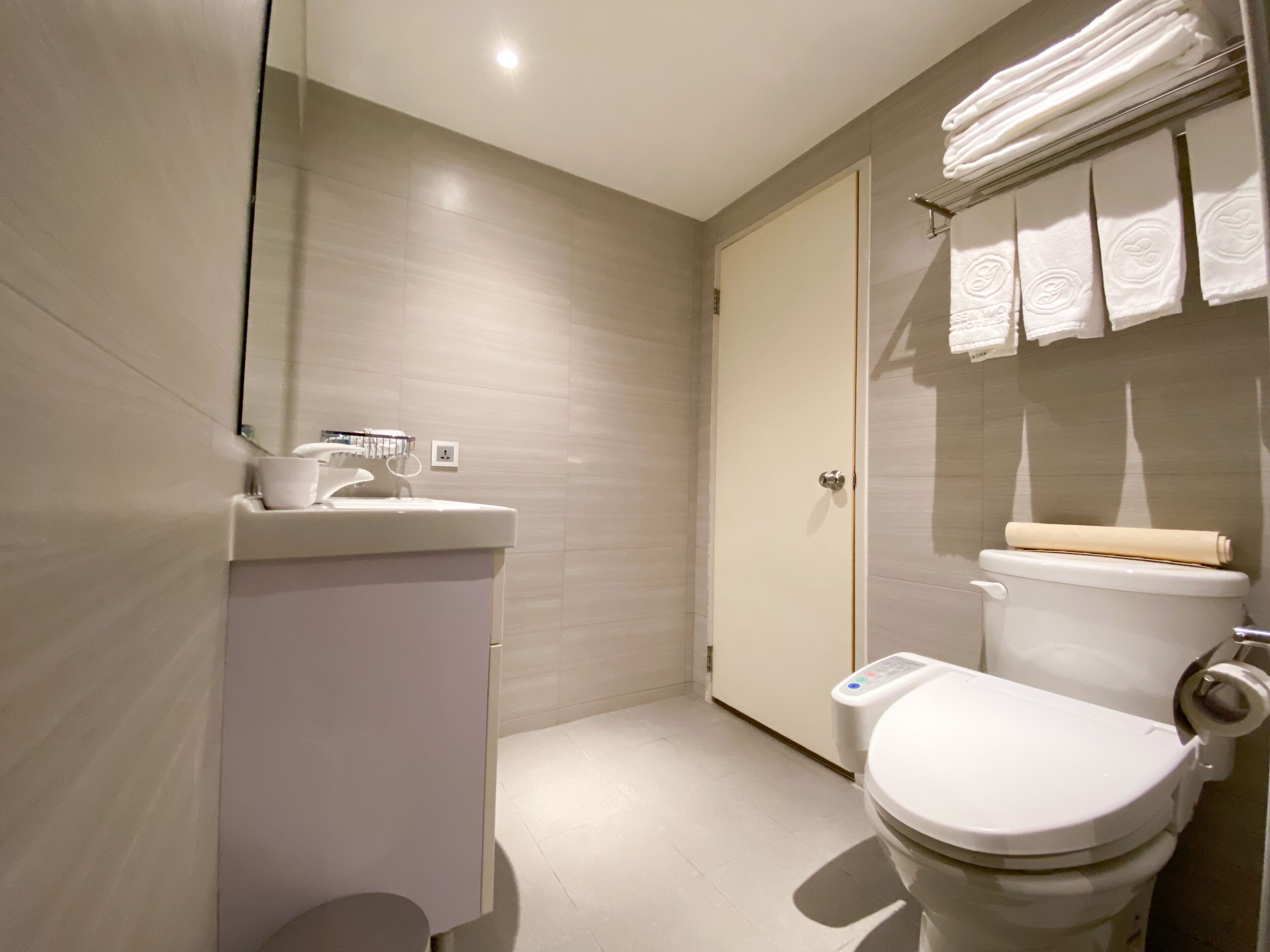 deluxe quadruple room, 4 single beds | bathroom | hair dryer, towels, toilet paper