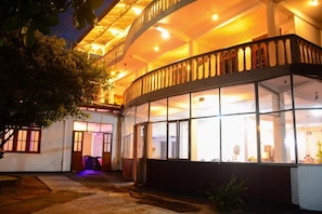 A multi-story building with a balcony and large windows. - Shanthi beach resort (Unawatuna)