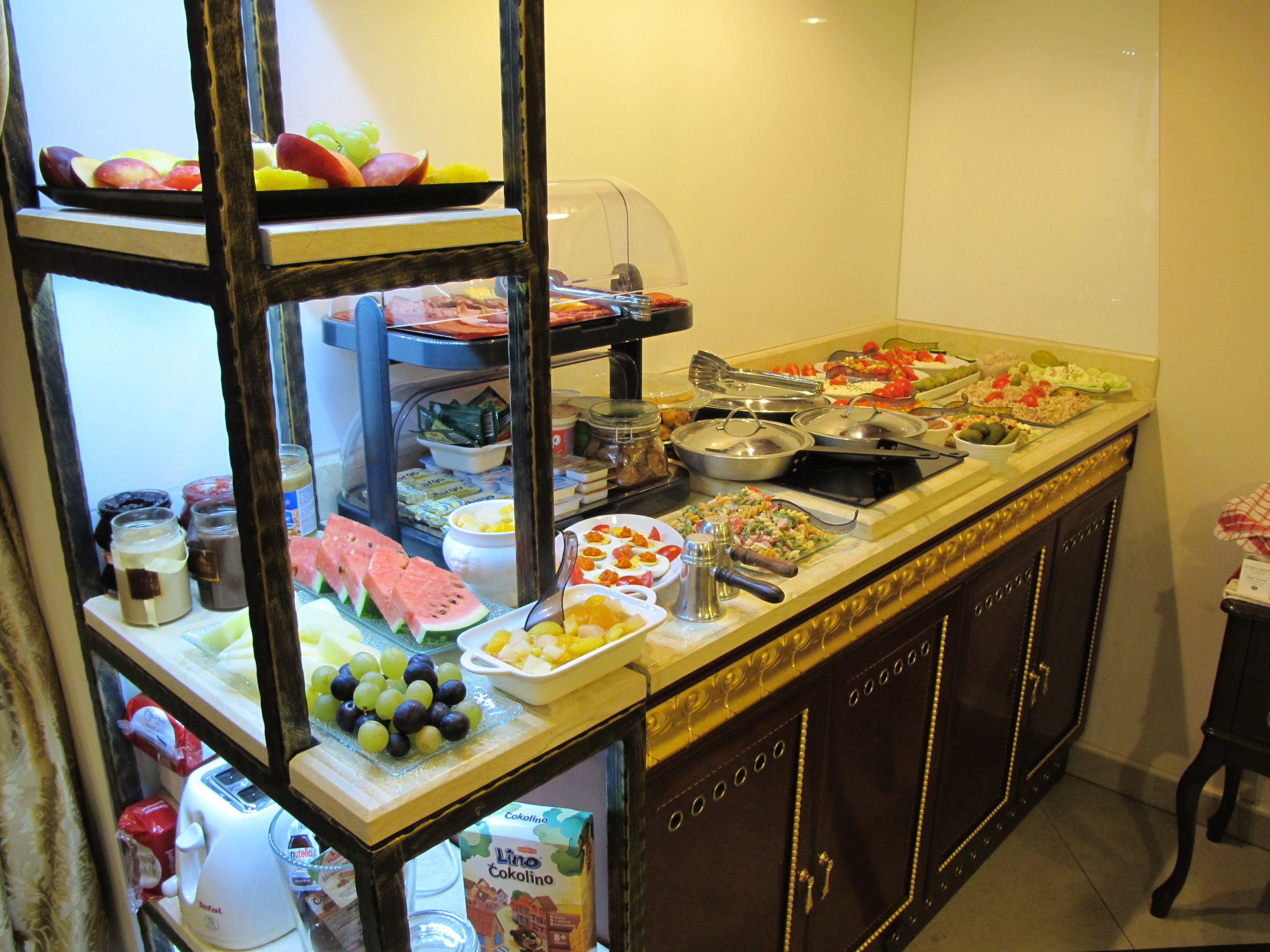 A buffet with various food items and condiments.
