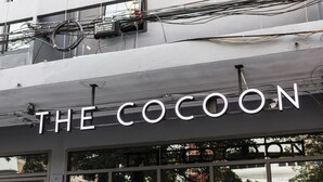 A building with a sign that reads "THE COCOON". - The Cocoon Hostel (Bangkok)