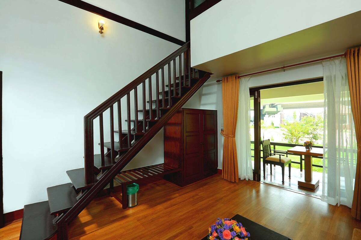 A staircase with wooden railings leading to a landing.