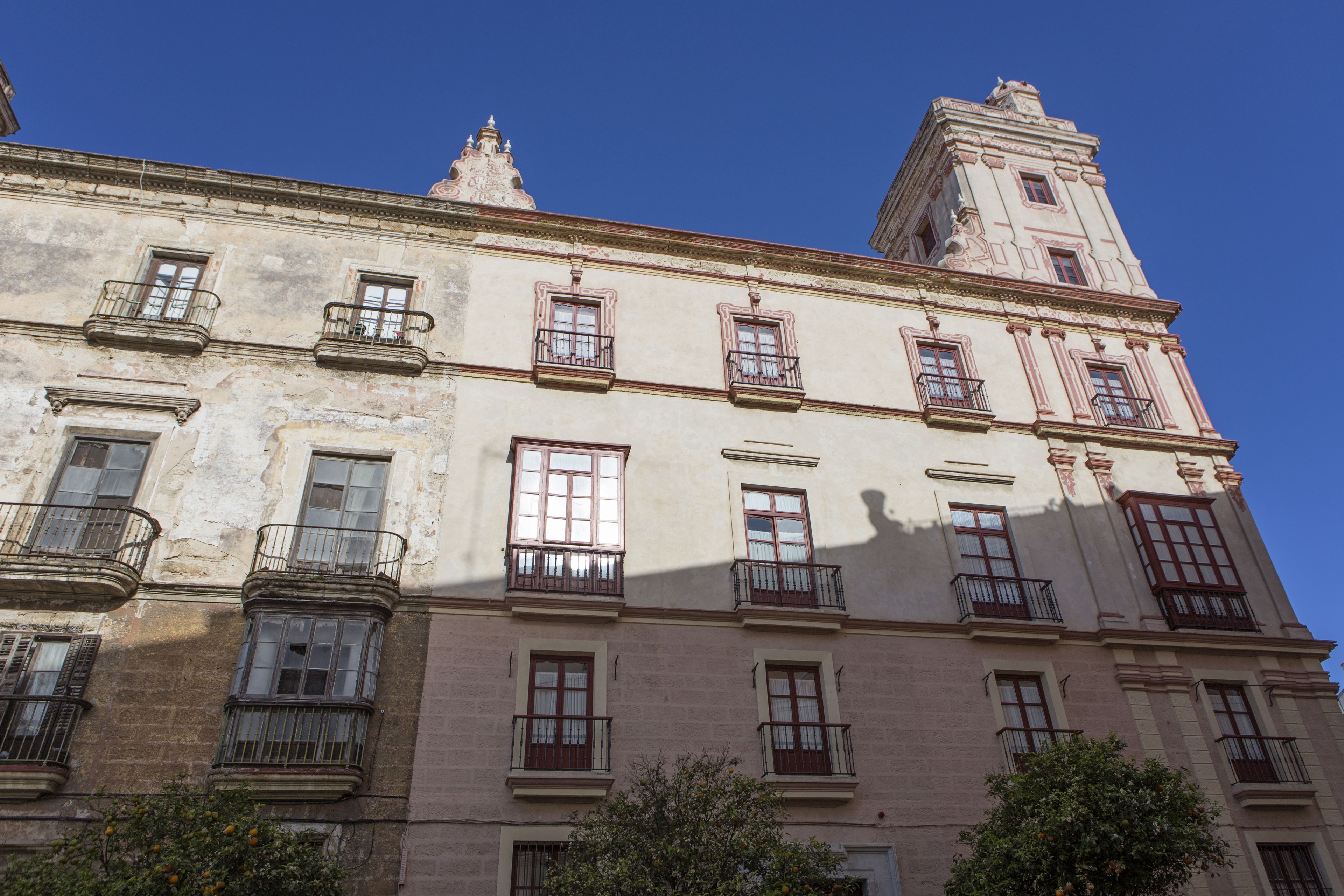 A historic building with multiple windows and balconies, featuring classic architectural details.