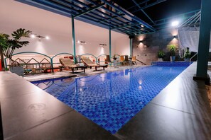 An indoor swimming pool with blue mosaic tiles, lounge chairs, and potted plants. - DAHLIALAND SAIGON HOTEL & SWIMMING POOL (Ho Chi Minh City)