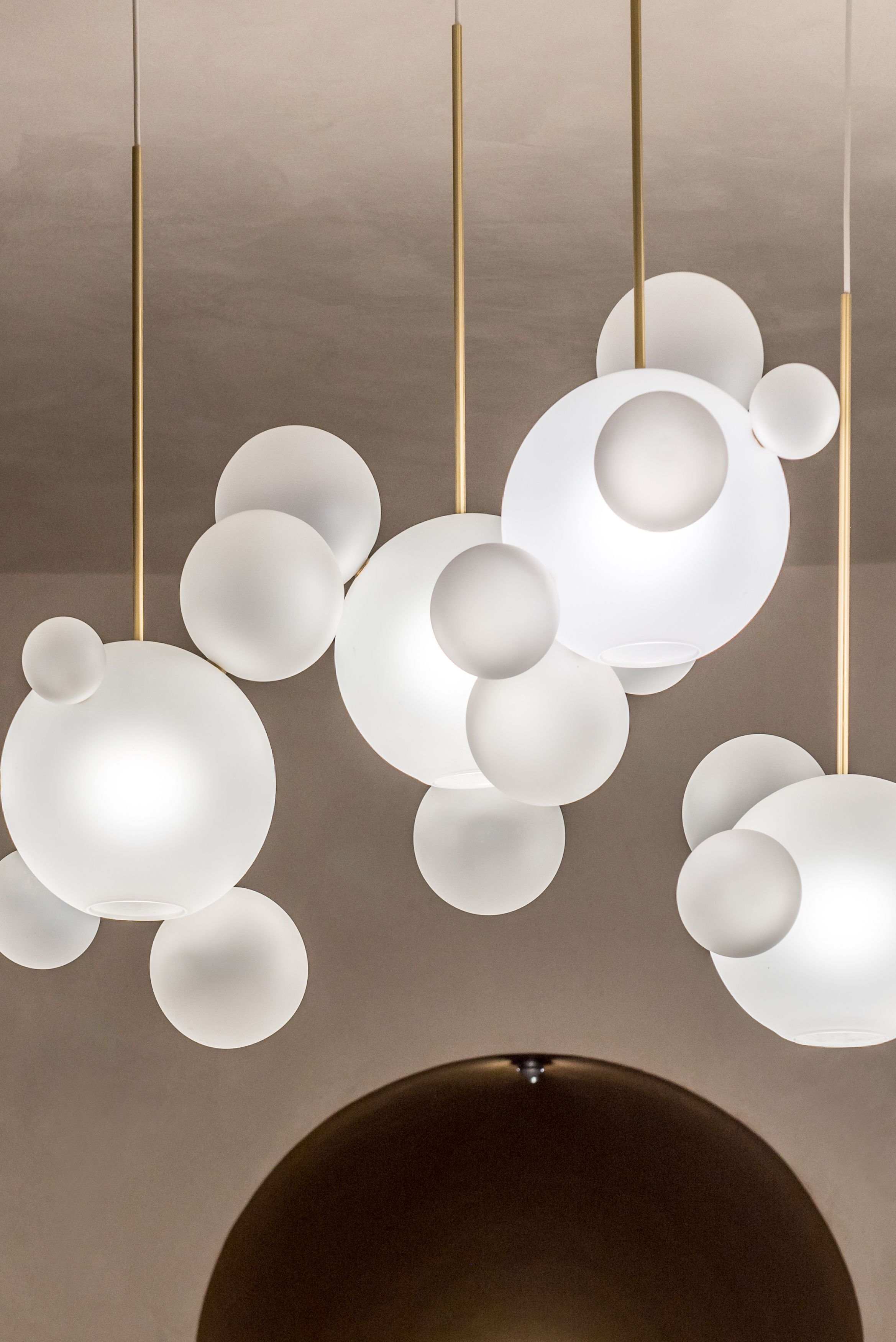 A modern chandelier with multiple spherical light fixtures suspended from the ceiling.