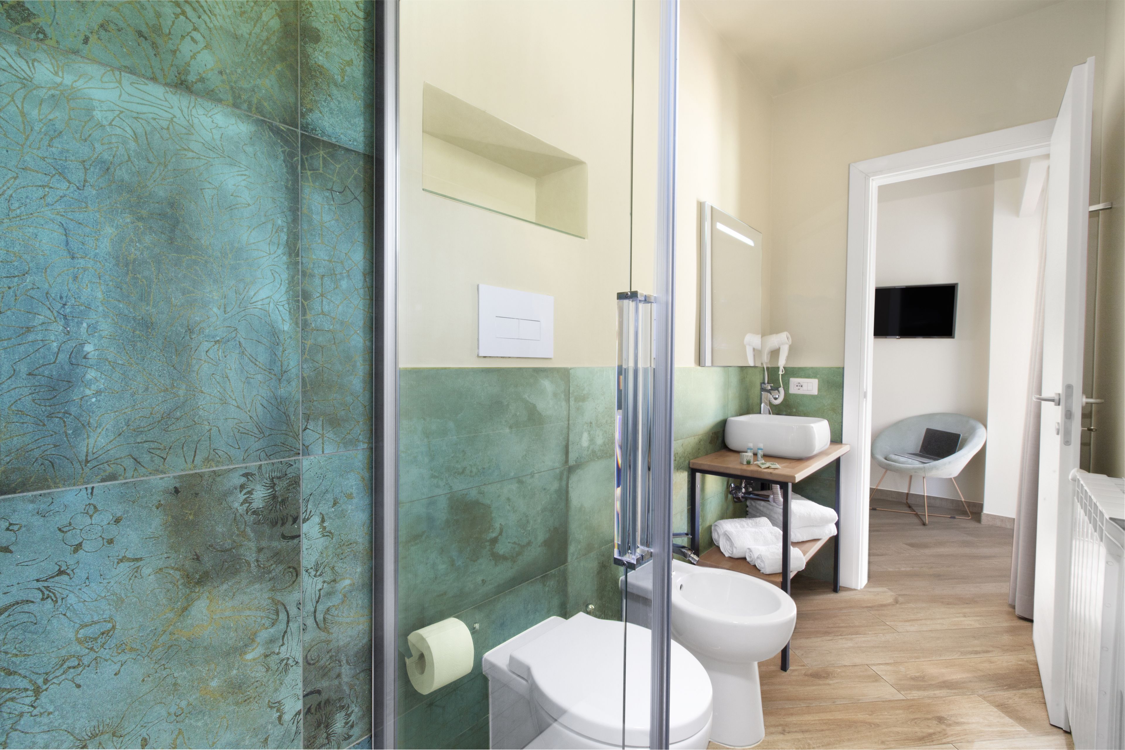 A bathroom with a shower, toilet, and sink.
