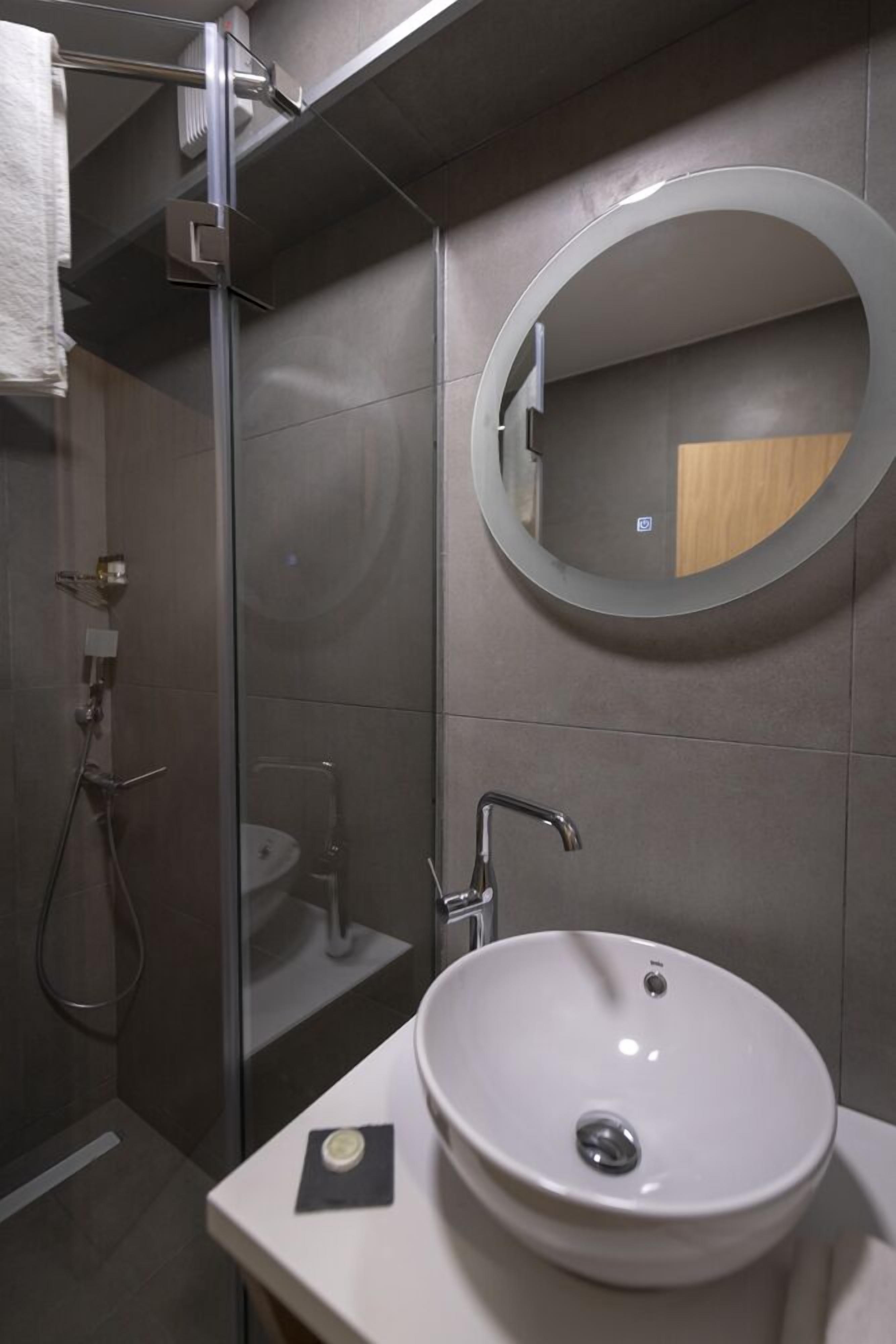 economy room | bathroom | shower, free toiletries, hair dryer, bathrobes