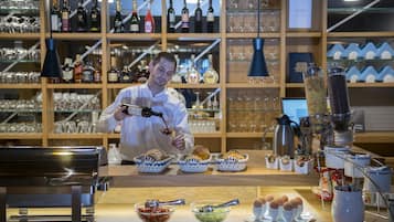 A chef preparing food in a kitchen with various cooking utensils and ingredients.