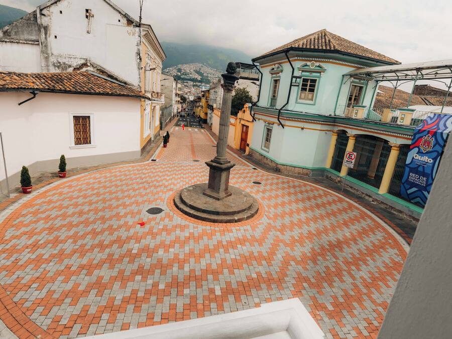 A circular plaza with a central monument, surrounded by buildings with traditional architecture.