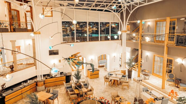 A spacious indoor area with a high ceiling, multiple seating areas, and a central decorative element. - Hotel Mama Cuchara by Art Hotels Ecuador (Quito)