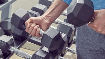 A person lifting a dumbbell with a weight marked as 45 lbs.