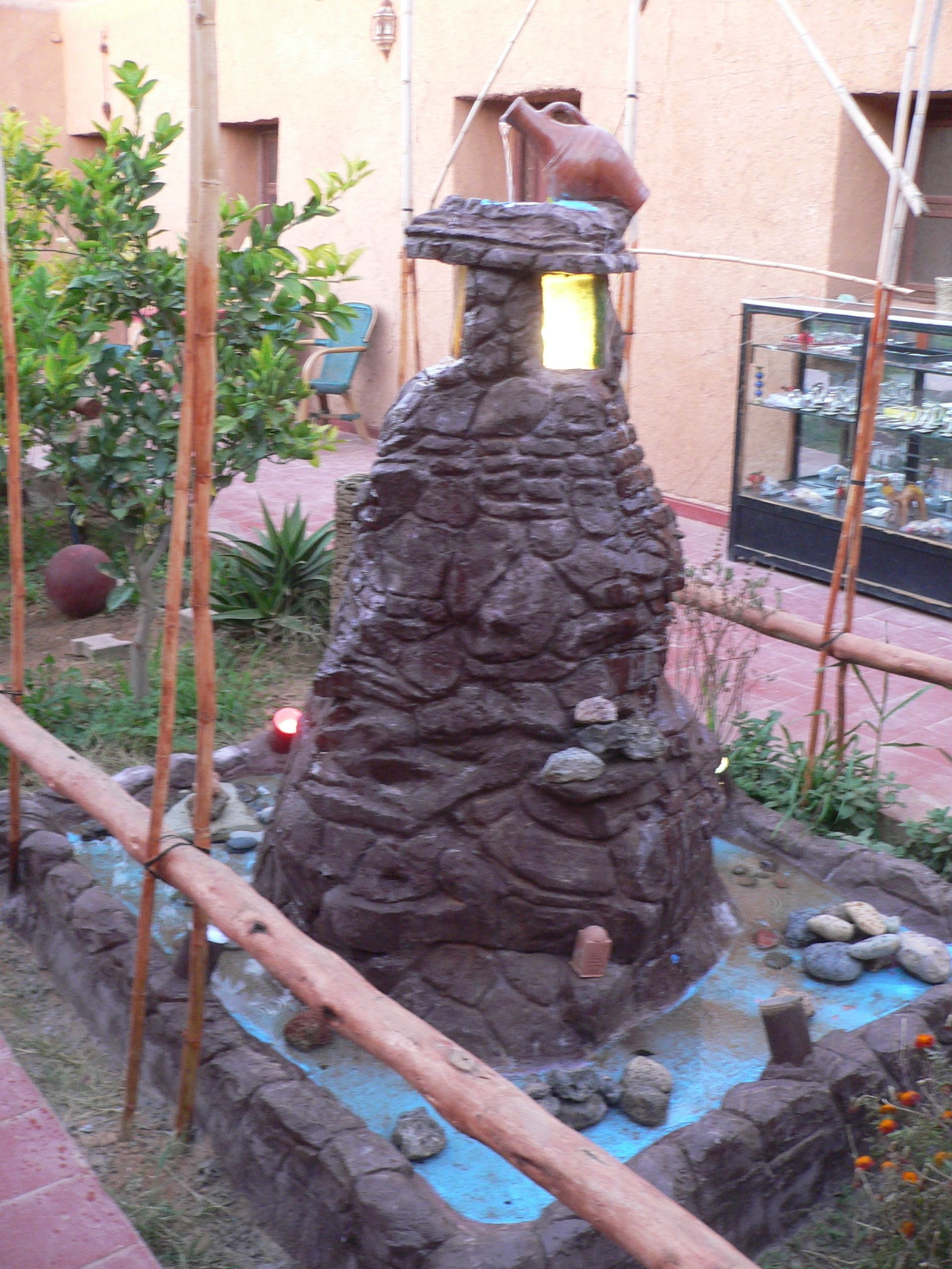 A rock garden with a water feature and a small pond.