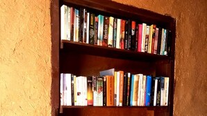 A bookshelf with multiple shelves filled with books. - Tarmguist (Asrir)