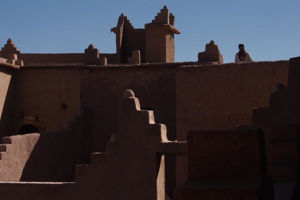 A traditional building with a series of steps leading up to a flat roof.