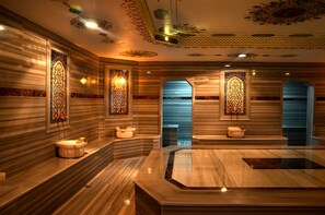 A luxurious bathroom with marble walls, ornate stained glass windows, and a central marble sink. - Cinarpark Hotel (Korfez)
