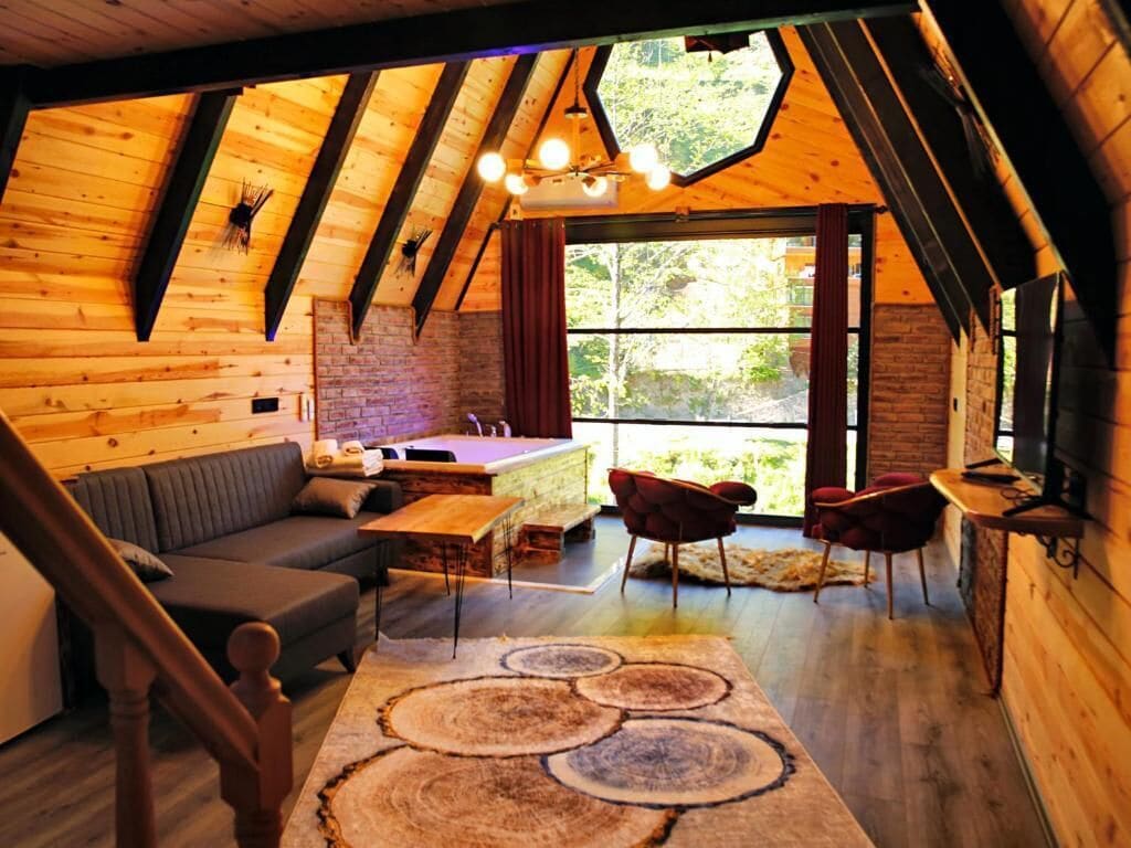 Luxury Suite, Jetted Tub, River View | Living area | 54-inch LED TV with cable channels, TV, fireplace