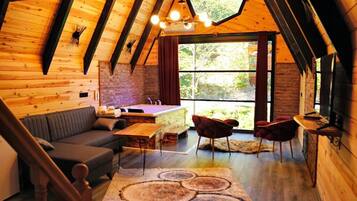 Luxury Suite, Jetted Tub, River View | Living area | 54-inch LED TV with cable channels, TV, fireplace