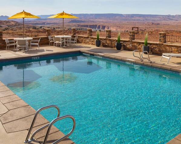 Seasonal outdoor pool, open 6:30 AM to 7:30 PM, pool umbrellas