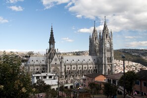 A large cathedral with intricate Gothic architecture, featuring multiple spires and a prominent clock tower. - Old Town Quito Suites, Apartments & Boutique hotel (Quito)