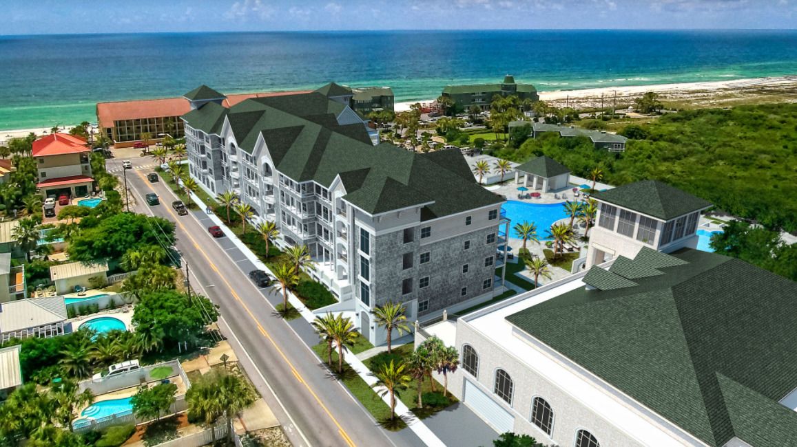 Een resort met meerdere gebouwen, een zwembad en uitzicht op het strand.