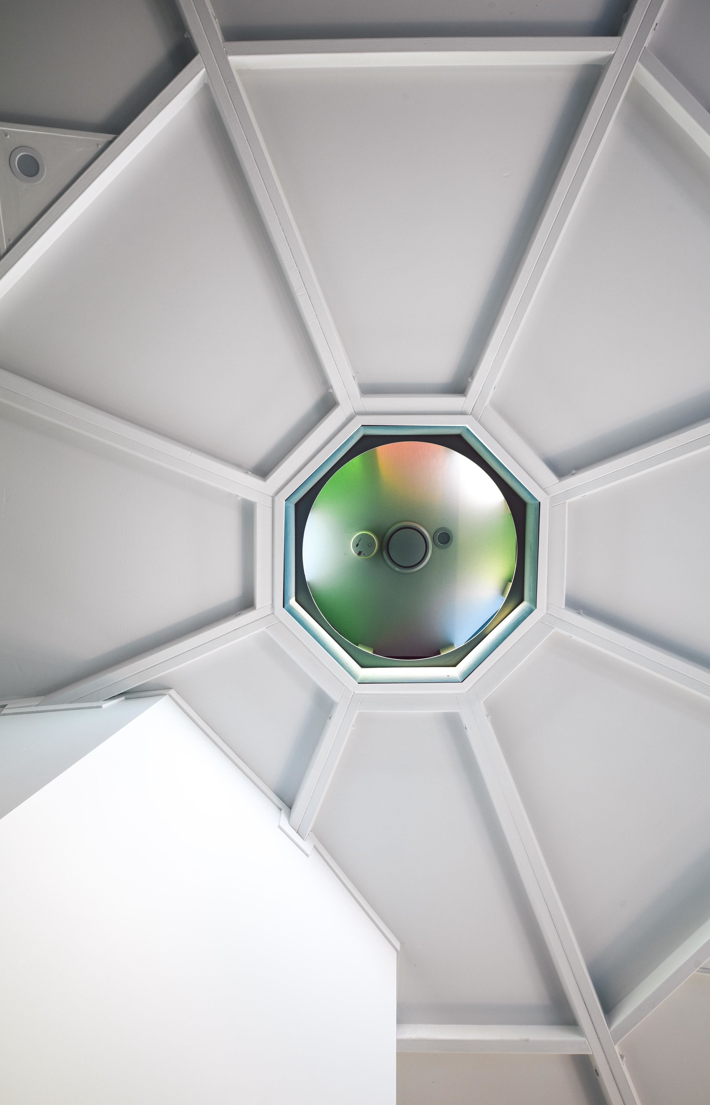 A ceiling with a hexagonal skylight.